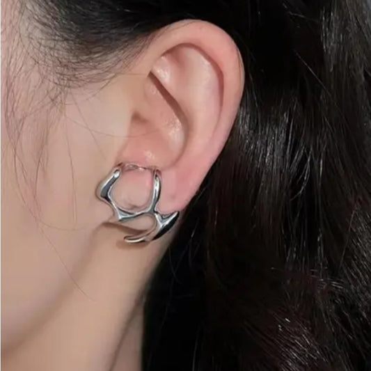 Close-up of an ear wearing a silver earring