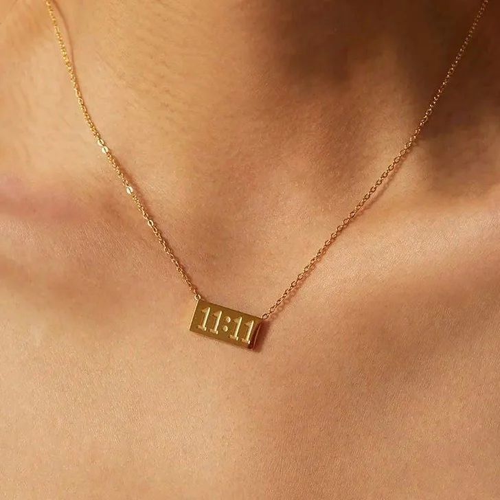 Gold necklace with '11:11' pendant