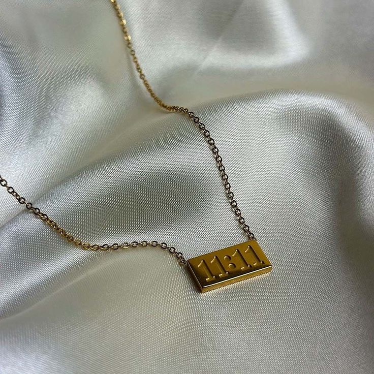 Gold necklace with '11:11' pendant