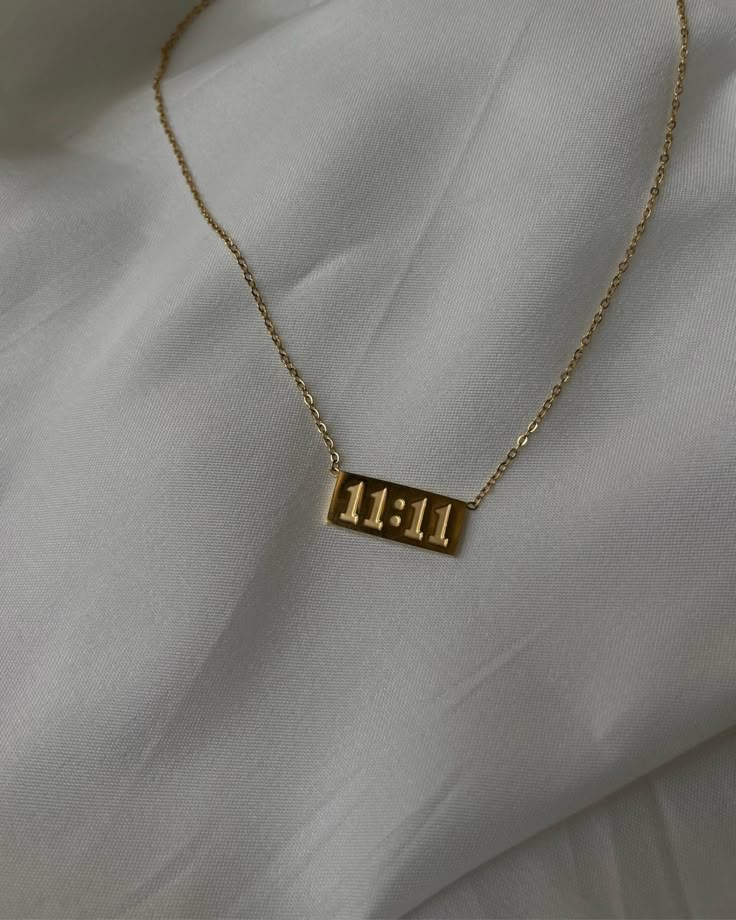 Gold necklace with '11:11' pendant