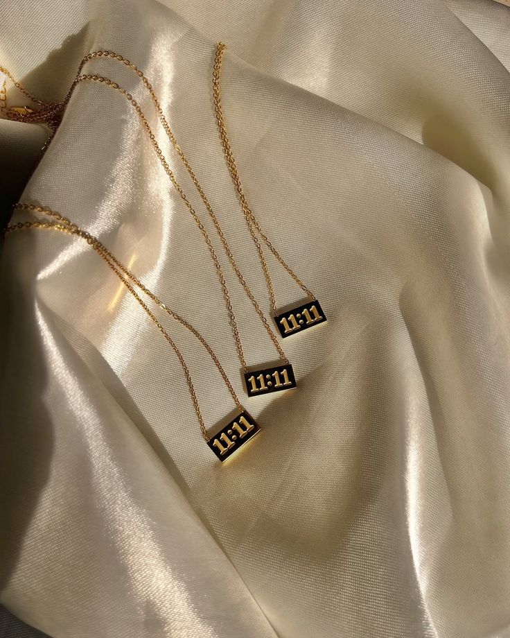 Gold necklace with '11:11' pendant
