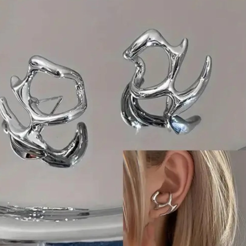 Close-up of an ear wearing a silver earring