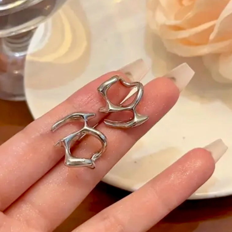 Close-up of an ear wearing a silver earring