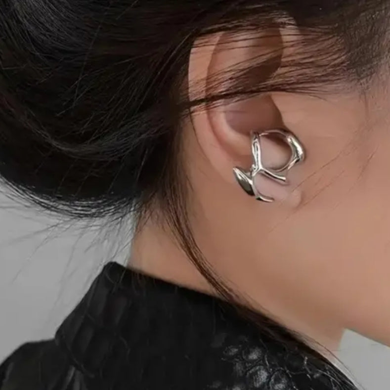 Close-up of an ear wearing a silver earring