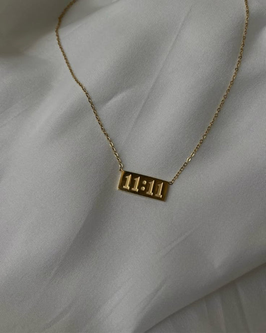 Gold necklace with '11:11' pendant