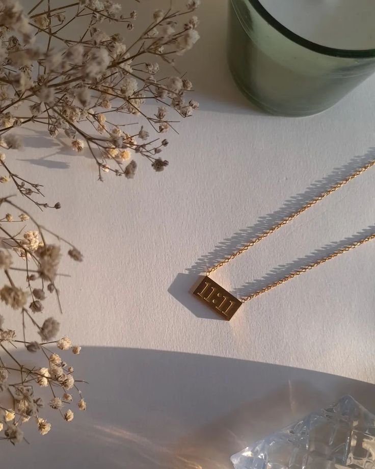 Gold necklace with '11:11' pendant